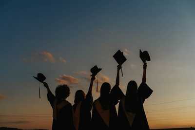 Image of graduates with caps in the air